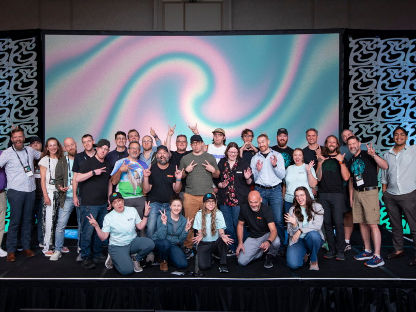 Moov Financial make silly faces while posing for a large group photo